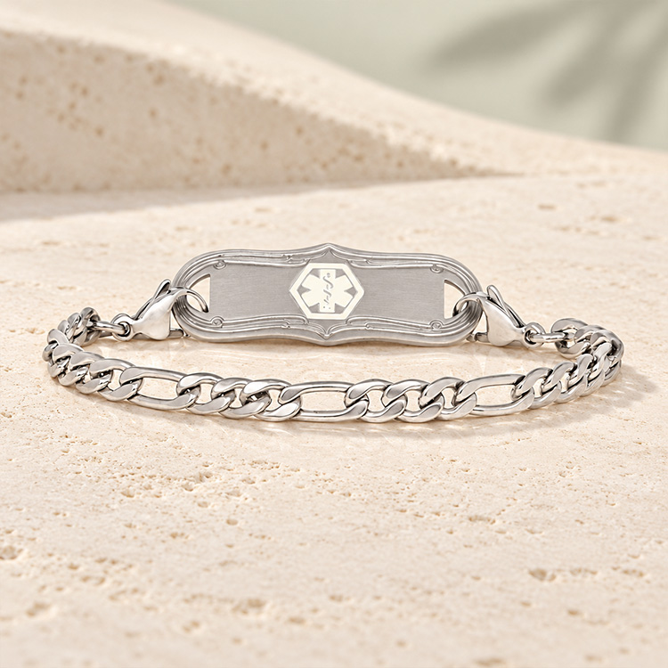 Classic stainless steel medical ID figaro chain bracelet with medical ID tag on marble background