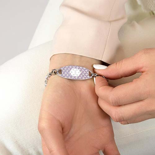 Woman wearing decorative medical alert tag with lavender and silver accents