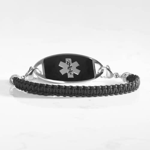 1. Silver-tone medical ID bracelet with black woven band, black ID tag, and prominent silver medical symbol.