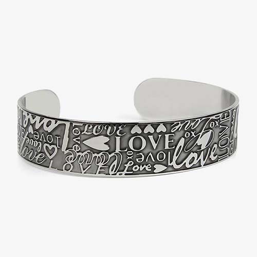 Front of Love Medical ID Cuff with embossed hearts, XO hugs and kisses, the word, "LOVE," in varied prints and scripts