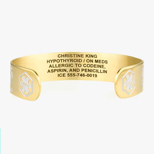 Golden Filigree Medical ID Cuff. Stainless yellow gold tone filigree pattern inset with pearlescent finish. White caduceus
