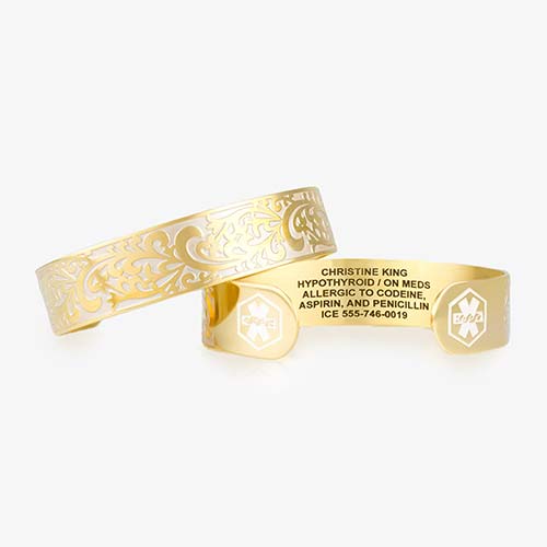 Gold tone medical alert cuff with floral swirls and premium laser custom engraving