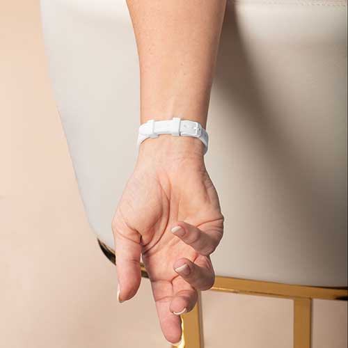 Woman wearing white silicone medical ID bracelet with watch style clasp