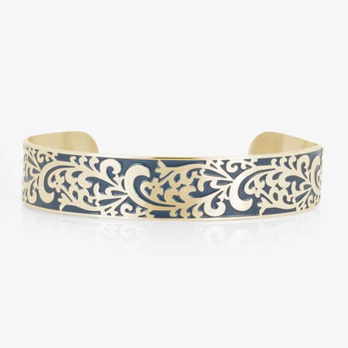 Gold-tone medical ID cuff featuring an intricate filigree pattern with blue accents across the front.