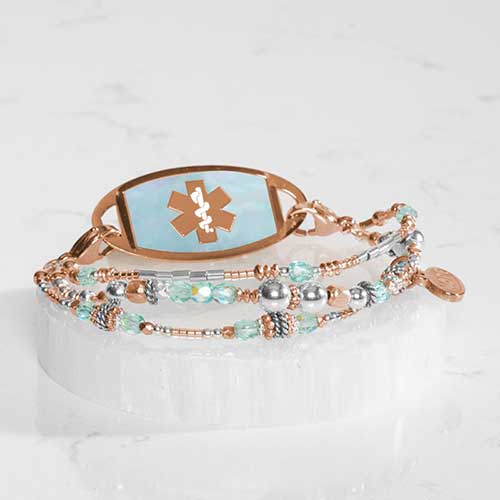 Interchangeable multi strand bracelet: Sterling silver, crystal, and rose gold tone beads attached to rose gold tone and Blue Mother of Pearl inlaid medical ID tag