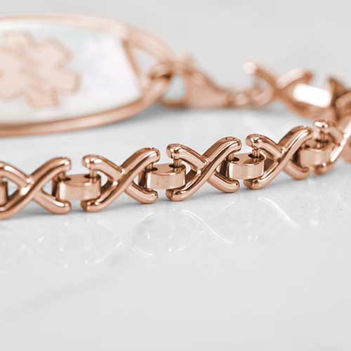 Close up of Rose Gold Lennox Medical ID Bracelet with Mother of Pearl tag on White Marble Counter