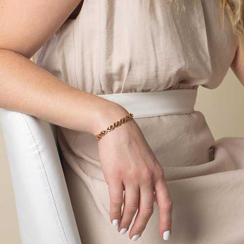 Relaxed woman wearing Rose Gold Lennox Medical ID Bracelet