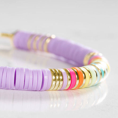 Close-up of bracelet details on the Girl Power Medical Alert Bracelet, showcasing colorful heishi beads in lavender, gold, and rainbow tones