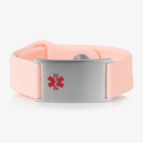 A pale pink silicone medical ID bracelet with a brushed stainless steel ID plate featuring a red medical alert symbol (Star of Life) on the front.