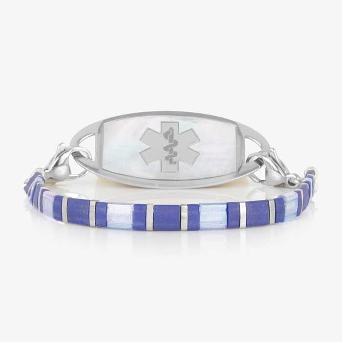 Silver-tone medical ID bracelet featuring a mother-of-pearl ID tag with Star of Life symbol and blue tile-style beaded bracelet chain.