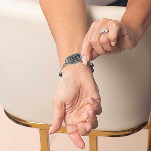 Sample engraved text on back of medical ID tag shown on wrist
