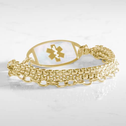 Three strand gold tone chain medical ID bracelet with decorative gold tone stainless steel med ID tag with mother of pearl inlay and gold symbol