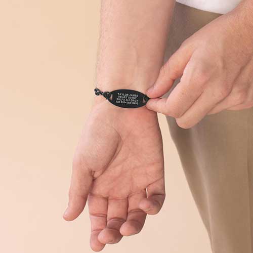 Man displaying custom engraved Lauren's Hope medical ID tag.