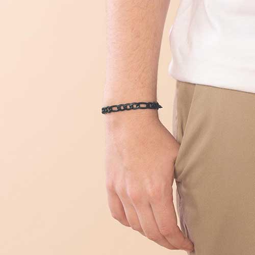 Man wearing sandblasted black figaro style chain.