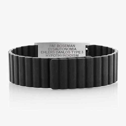 Low back angle of black silicone, magnetic band with a silver tag.