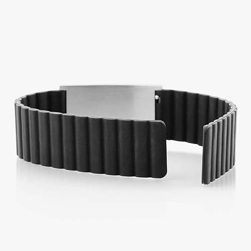Low back angle of black silicone, magnetic band with silver tag and open band.