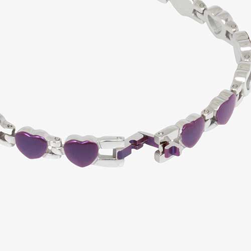 Stainless steel and purple toned heart shaped links in an open and closed heart pattern with "L" shaped clasp opened.