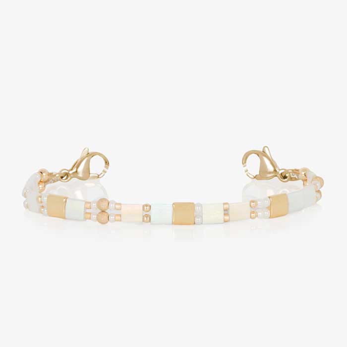 White and gold beaded stretch medical ID bracelet paired with gold tone stainless steel medical ID tag with mother of pearl inlay and gold tone medical symbol.