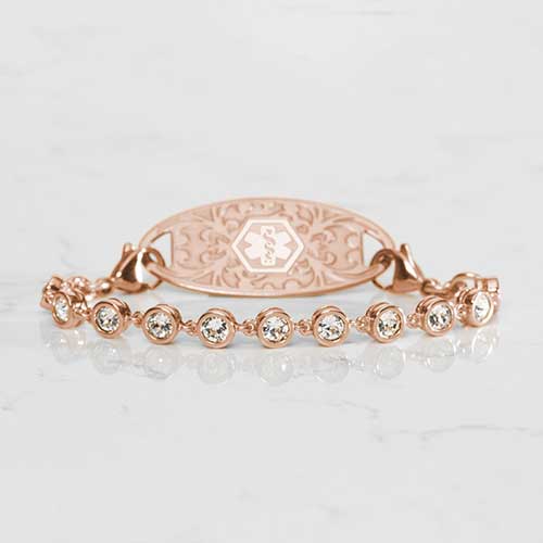 Ella Medical ID Bracelet in Rose Gold with round, bezel set, Cubic Zirconia Crystals paired with Rose Gold Gardenia Medical ID Tag on White Marble Couter