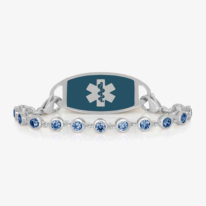 Rhodium and palladium plated women's medical alert bracelet with sapphire tone, round, bezel set cubic zirconia crystals paired with stainless steel sapphire medical ID tag.