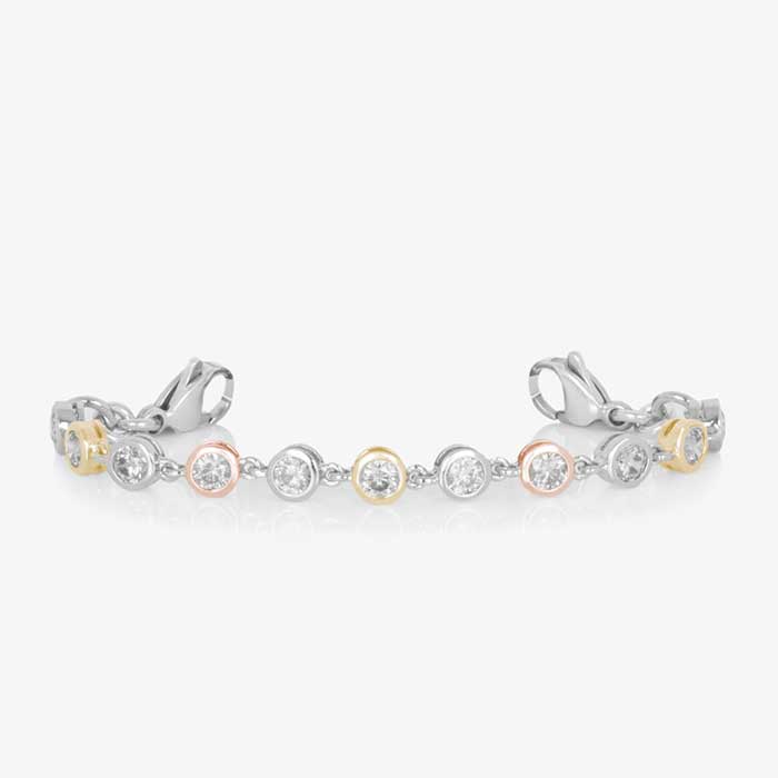 Bracelet featuring individually set, round cubic zirconia crystals, in alternating silver, rose and gold tones. Attached to a silver and gold medical ID tag.