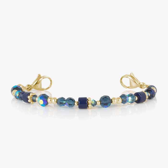 Blue and gold beaded medical ID bracelet on jewelry elastic with gold tone lobster clasps and sapphire blue decorative med ID tag.