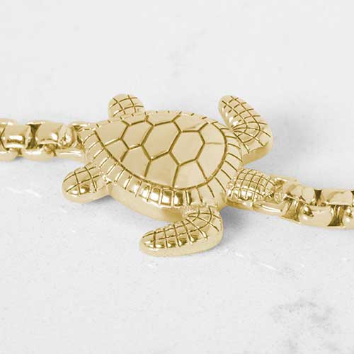Close up of gold tone sea turtle centerpiece