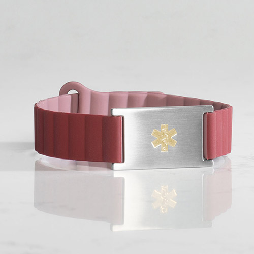 Urban MagSport Medical alert bracelet in Merlot on wrist, featuring an adjustable silicone band and stainless steel ID tag for a secure fit and clear visibility