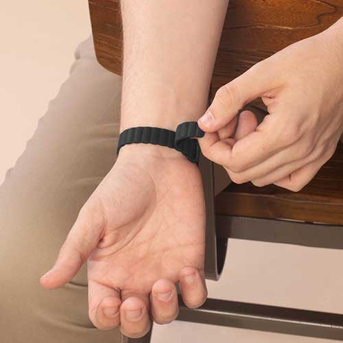 Comfortable Urban MagSport medical ID bracelet for men in black, on wrist, with a sleek magnetic silicone band and sandblasted black ID tag.