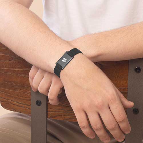 Urban MagSport Medical alert bracelet in black, shown on wrist with adjustable silicone band and stainless steel medical ID tag, perfect for sensitive skin.