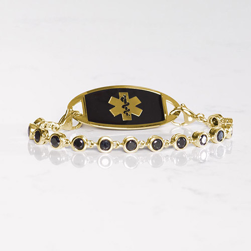 Gold medical ID bracelet with black crystal chain and black inlay plaque, featuring a Star of Life symbol for elegant safety wear.