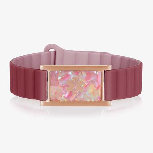 Urban MagSport bracelet displayed on white background with a clear view of the pink abalone faceplate and rose gold caduceus symbol, silicone band in merlot and mauve.