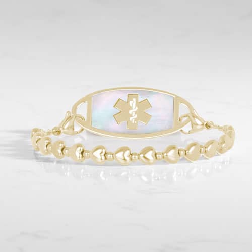 Gold beaded stretch medical alert bracelet with mother of pearl ID tag and caduceus symbol in elegant heart shape feminine design