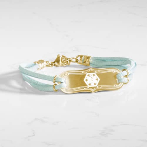 SmartSize Medical Id Bracelet with a light blue tone suede bands and adjustable chain attached to a Gold tone La Petite med ID tag