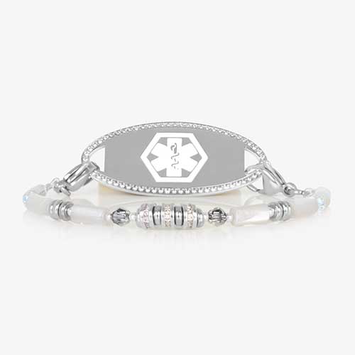 White mother-of-pearl medical ID bracelet with silver and crystal bead accents, interchangeable tag, and lobster clasp closure. Paired with a silver tone medical ID tag featuring a cubic zirconia border and white medical alert symbol.