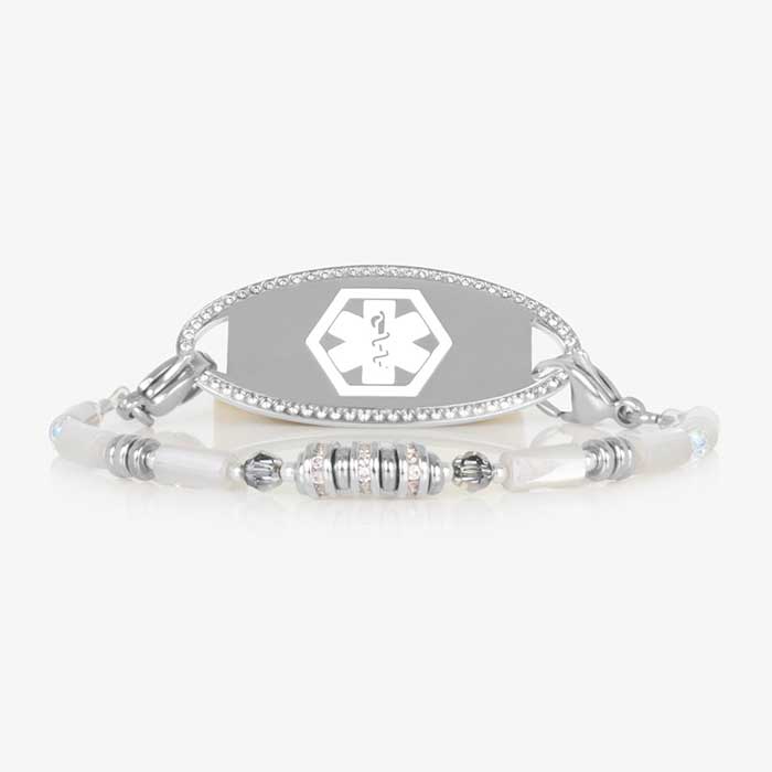 White mother-of-pearl medical ID bracelet with silver and crystal bead accents, interchangeable tag, and lobster clasp closure. Paired with a silver tone medical ID tag featuring a cubic zirconia border and white medical alert symbol.