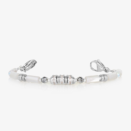 Close-up of silver and white beaded medical ID bracelet worn on wrist with slim profile and secure interchangeable clasp.