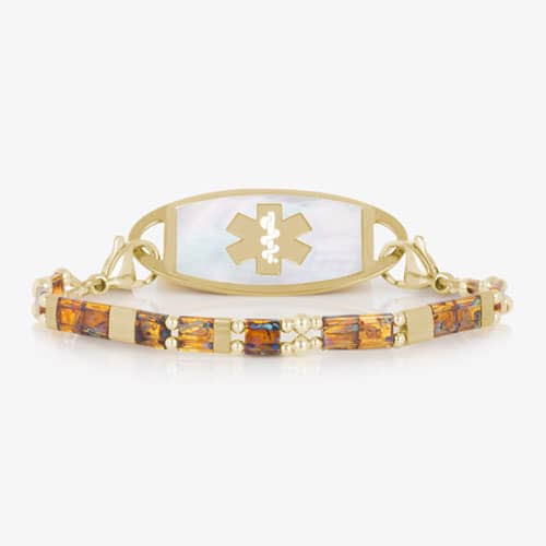 Amber-toned and gold-tone bracelet paired with a light inlay medical ID tag featuring a prominent medical symbol on the front.