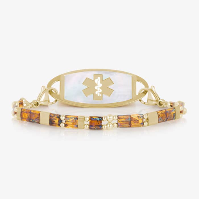 Amber-toned and gold-tone bracelet paired with a light inlay medical ID tag featuring a prominent medical symbol on the front.