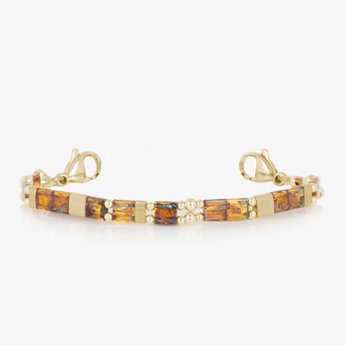 Amber-toned rectangular bracelet accents with gold-tone details and decorative round beads, shown with lobster clasps on a white background.