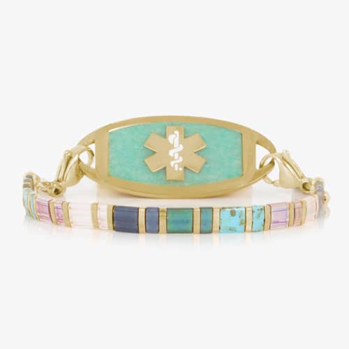 Gold-tone medical ID bracelet with colorful rectangular beads and an aqua-colored ID tag featuring a medical symbol.