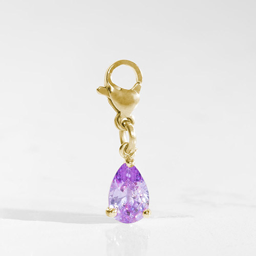 Teardrop-shaped amethyst Lynn charm in gold-tone setting, adding a vibrant pop of color to a Lauren’s Hope medical alert bracelet