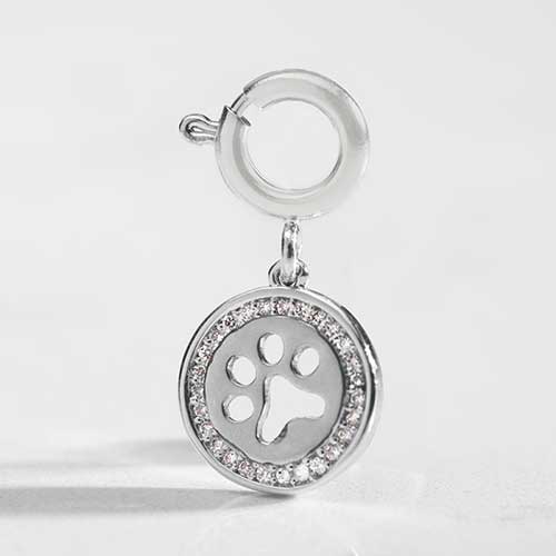 Detail shot of silver paw cut out charm