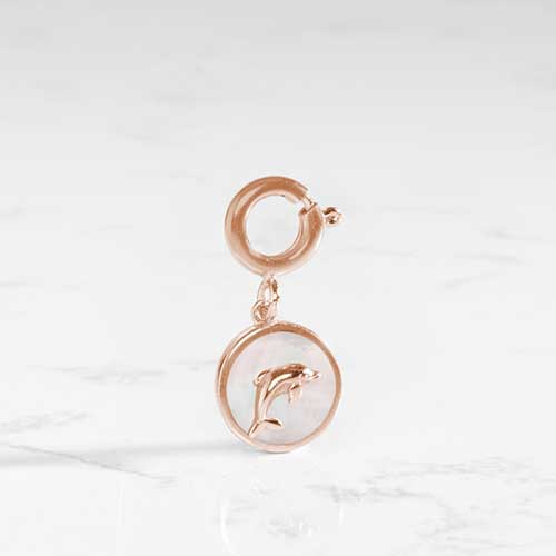 The mother of pearl inlay shines on this dolphin charm.