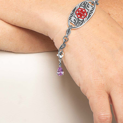 Teardrop-shaped Lynn Amethyst Charm in silver-tone prong setting, shown on Lauren’s Hope medical ID bracelet for women