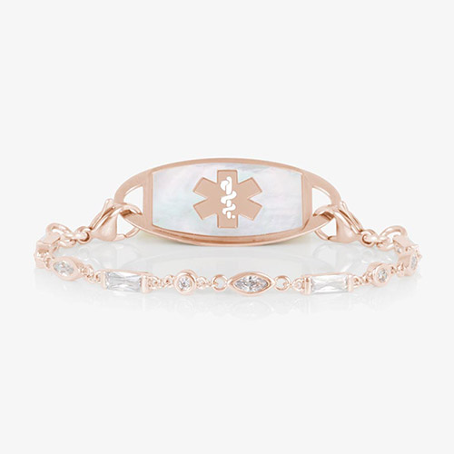 Rose gold tone medical ID bracelet with round, rectangle, and oval clear cubic zirconia crystals paired with rose gold tone med ID tag with mother of pearl inlay and rose gold medical symbol.