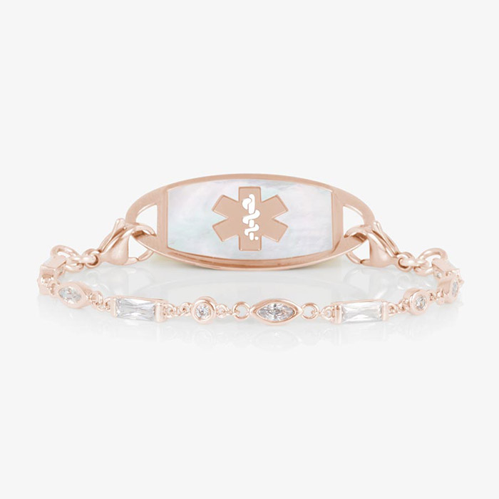 Rose gold tone medical ID bracelet with round, rectangle, and oval clear cubic zirconia crystals paired with rose gold tone med ID tag with mother of pearl inlay and rose gold medical symbol.