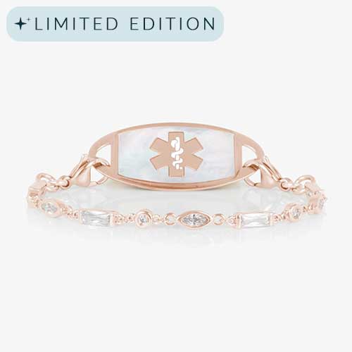 Rose gold tone medical ID bracelet with round, rectangle, and oval clear cubic zirconia crystals paired with rose gold tone med ID tag with mother of pearl inlay and rose gold medical symbol.
