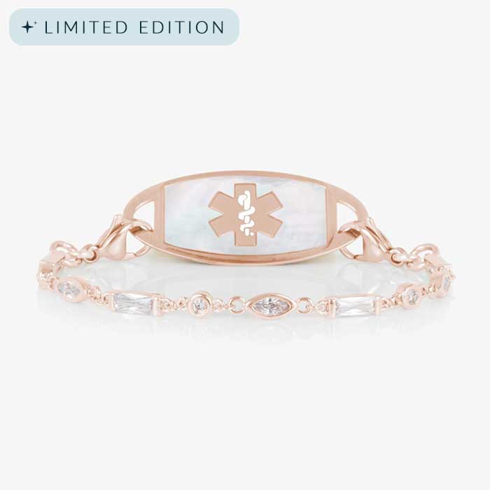 Rose gold tone medical ID bracelet with round, rectangle, and oval clear cubic zirconia crystals paired with rose gold tone med ID tag with mother of pearl inlay and rose gold medical symbol.