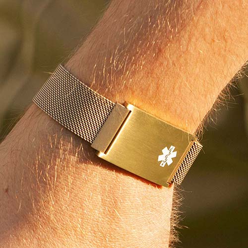 Man golfing and wearing stainless steel medical ID bracelet with magnetic clasp